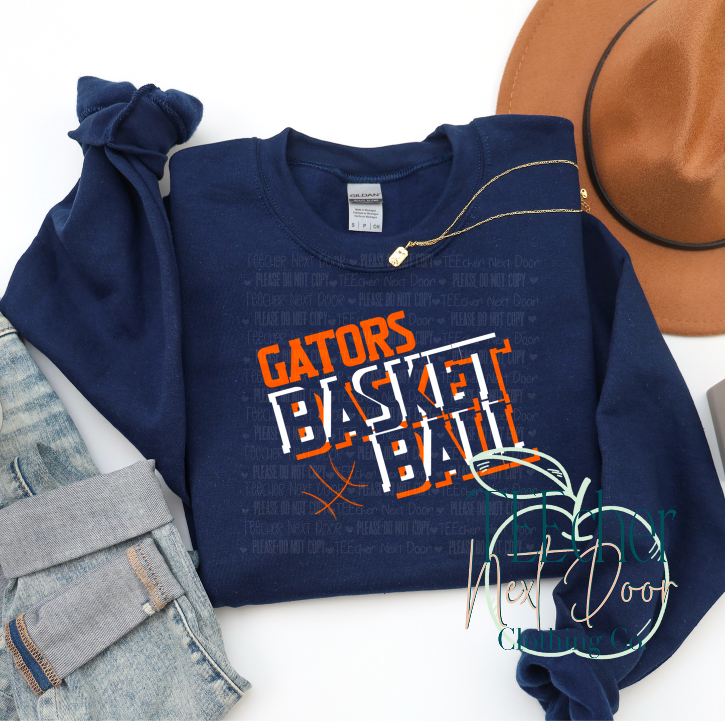 Navy blue sweatshirt with 'Gators Basketball' text and signature, next to a brown hat and denim jacket on a white background.